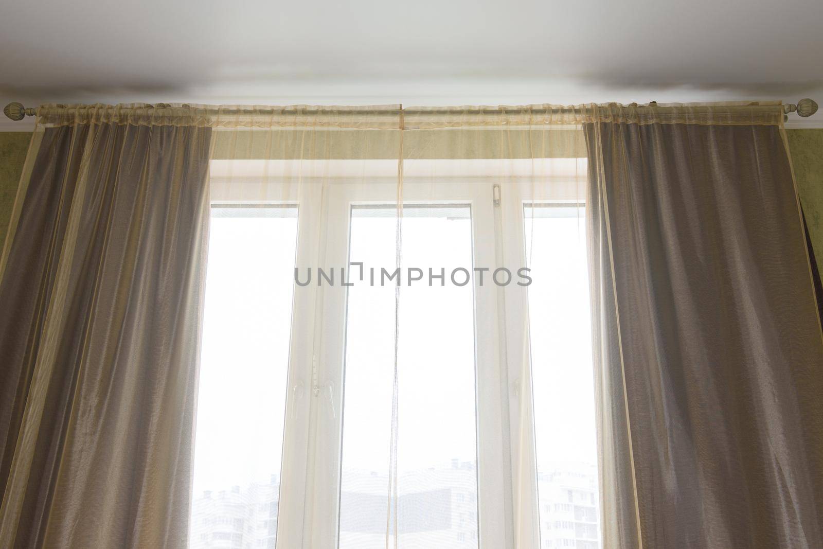 Curtains and tulle curtains large plastic windows in the apartment, close-up by Madhourse