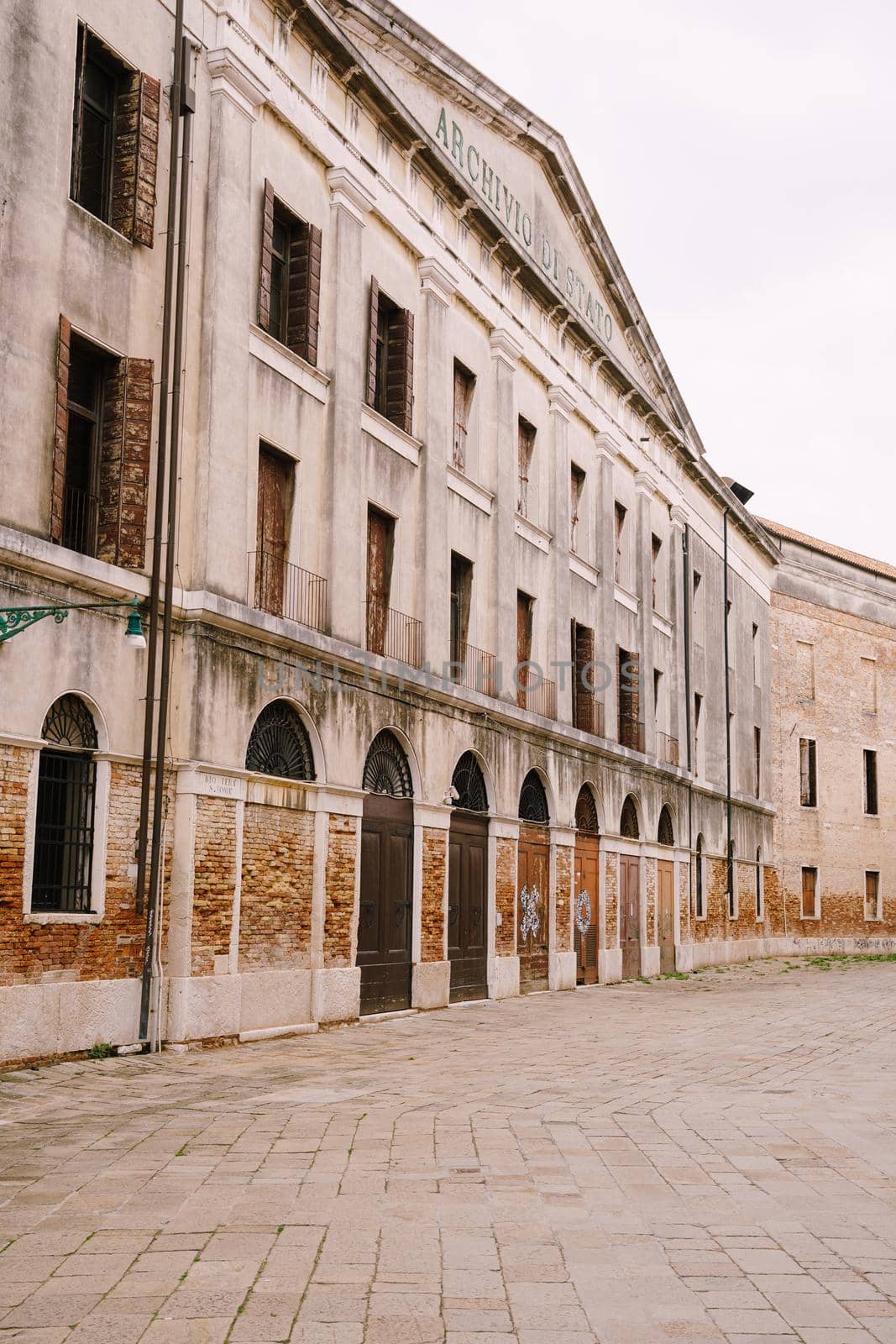A deserted street in Venice, Italy. The facade of the Venice State Archives building is Archivio di Stato di Venezia.