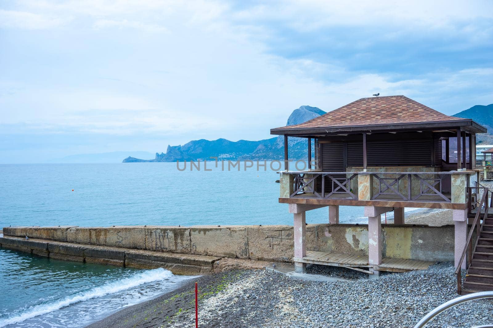 Seascape with a view of the Sudak embankment. Crimea