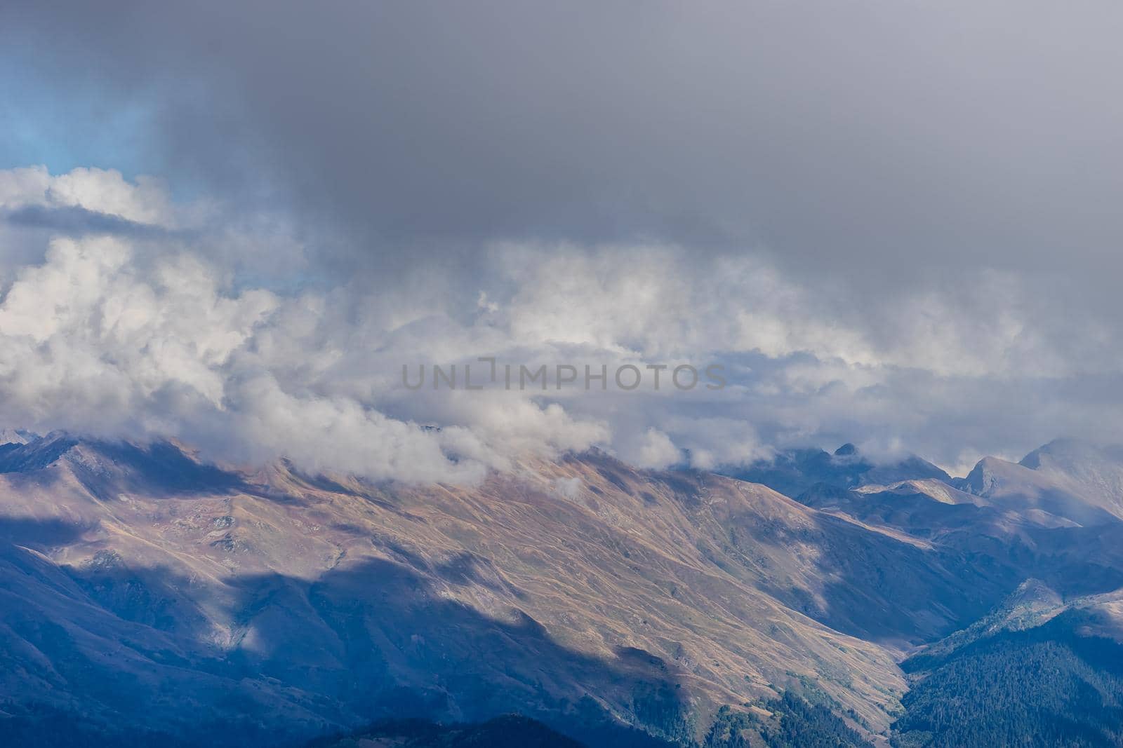 the top of the mountain on the background of the autumn sky and clouds