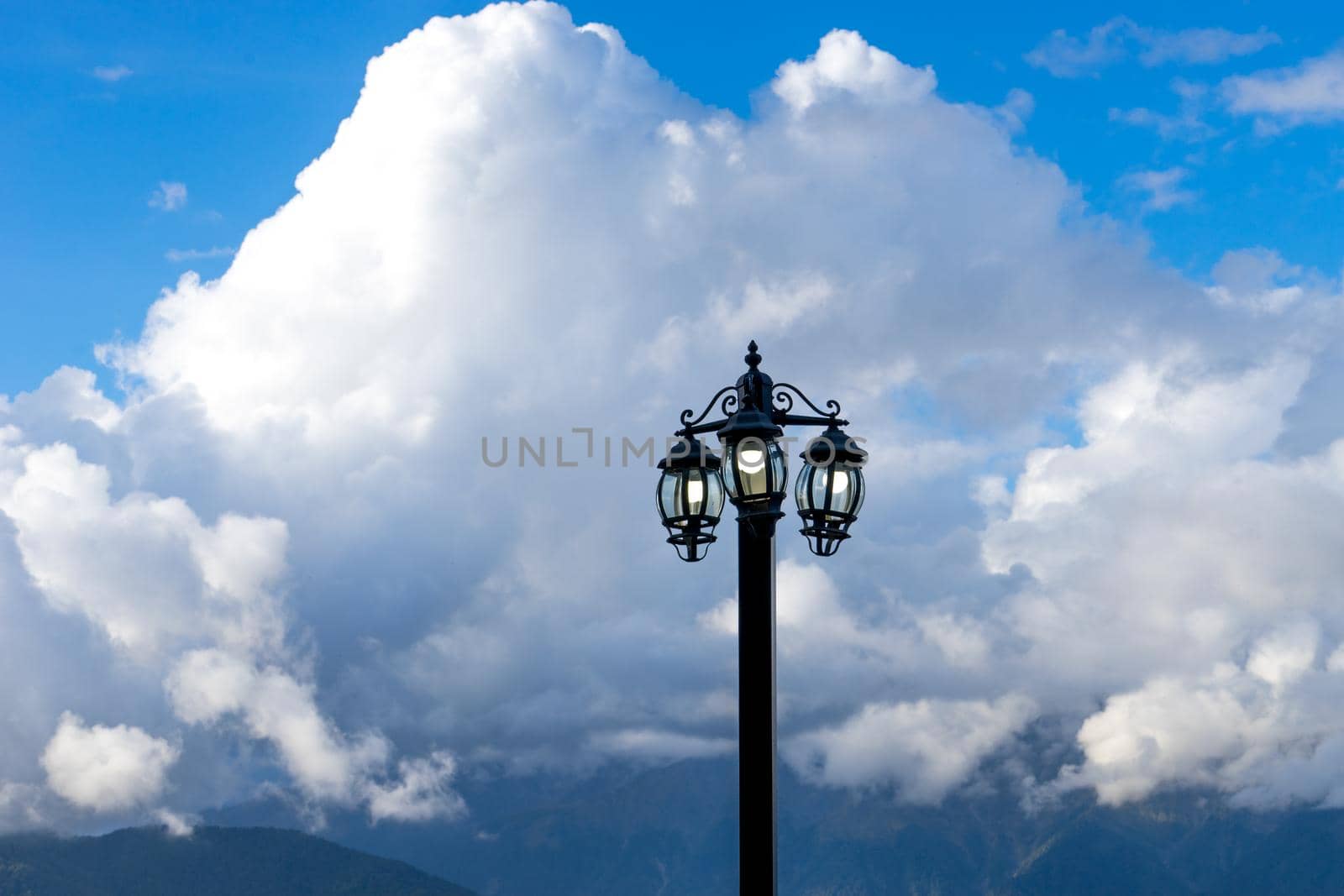 electric torch against a mountain landscape and clouds