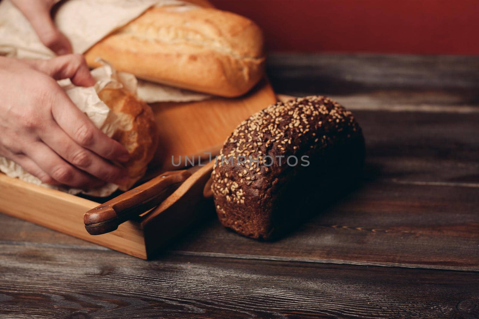 flour products rye bread on a tray and a sharp knife on the table. High quality photo