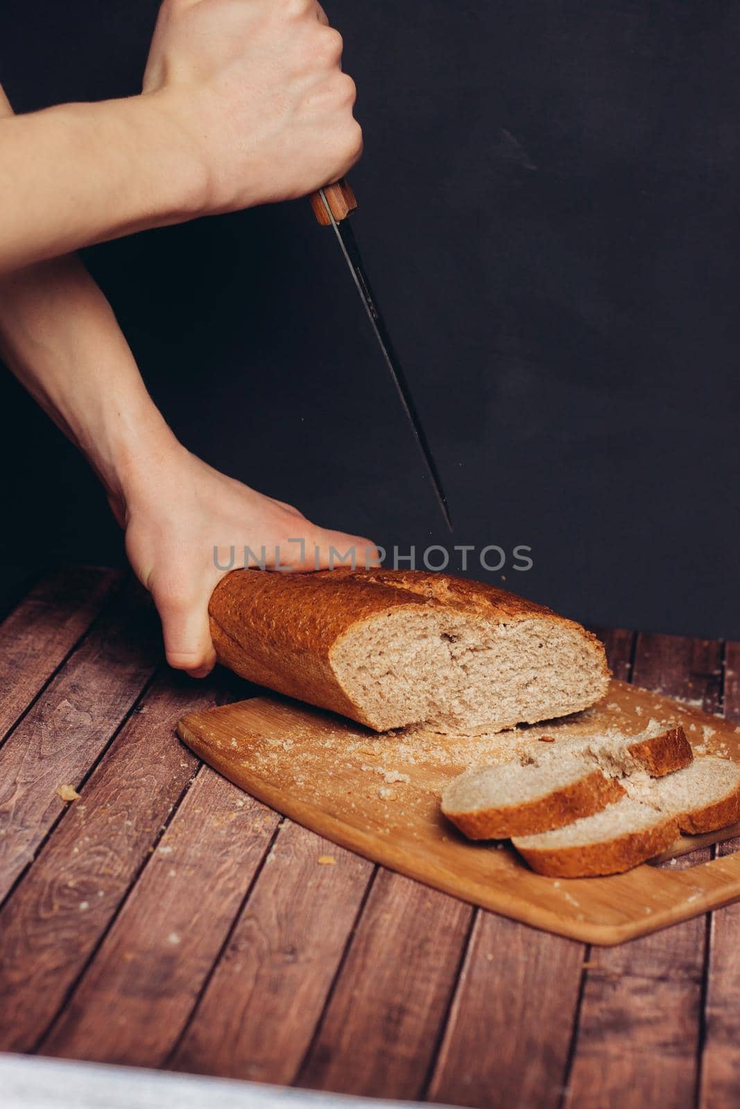 cutting a fresh loaf on a cutting board crispy bread by SHOTPRIME