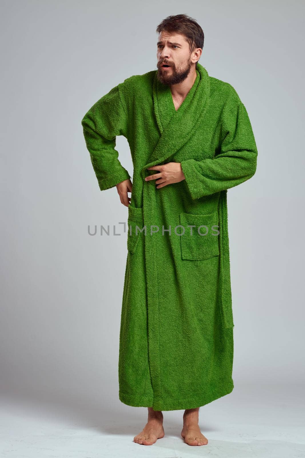 A bearded man in a green robe resting Comfort morning. High quality photo