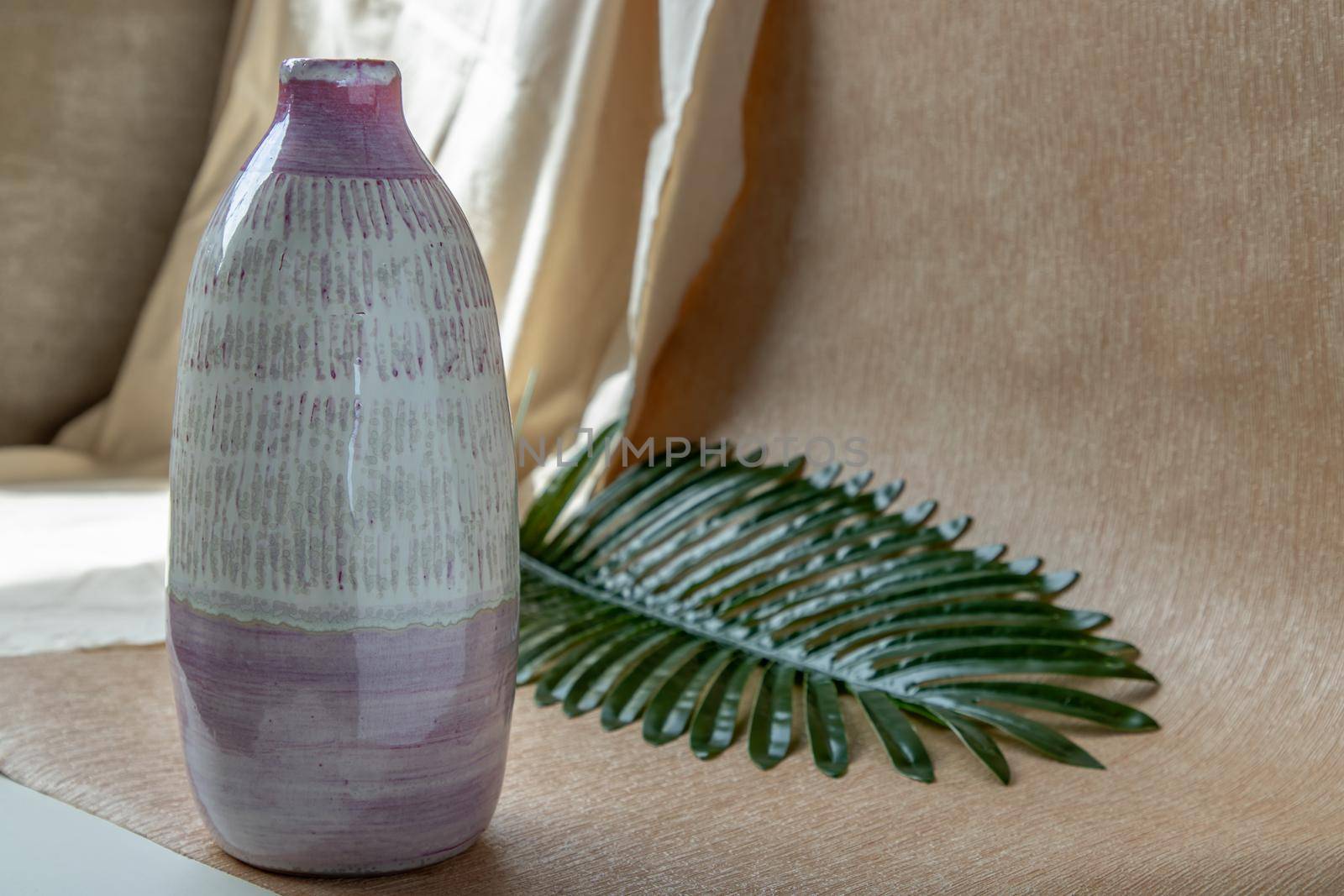 White and Pink Handmade ceramic vase on white textured table cloth. Home decor, Copy space, Selective focus.