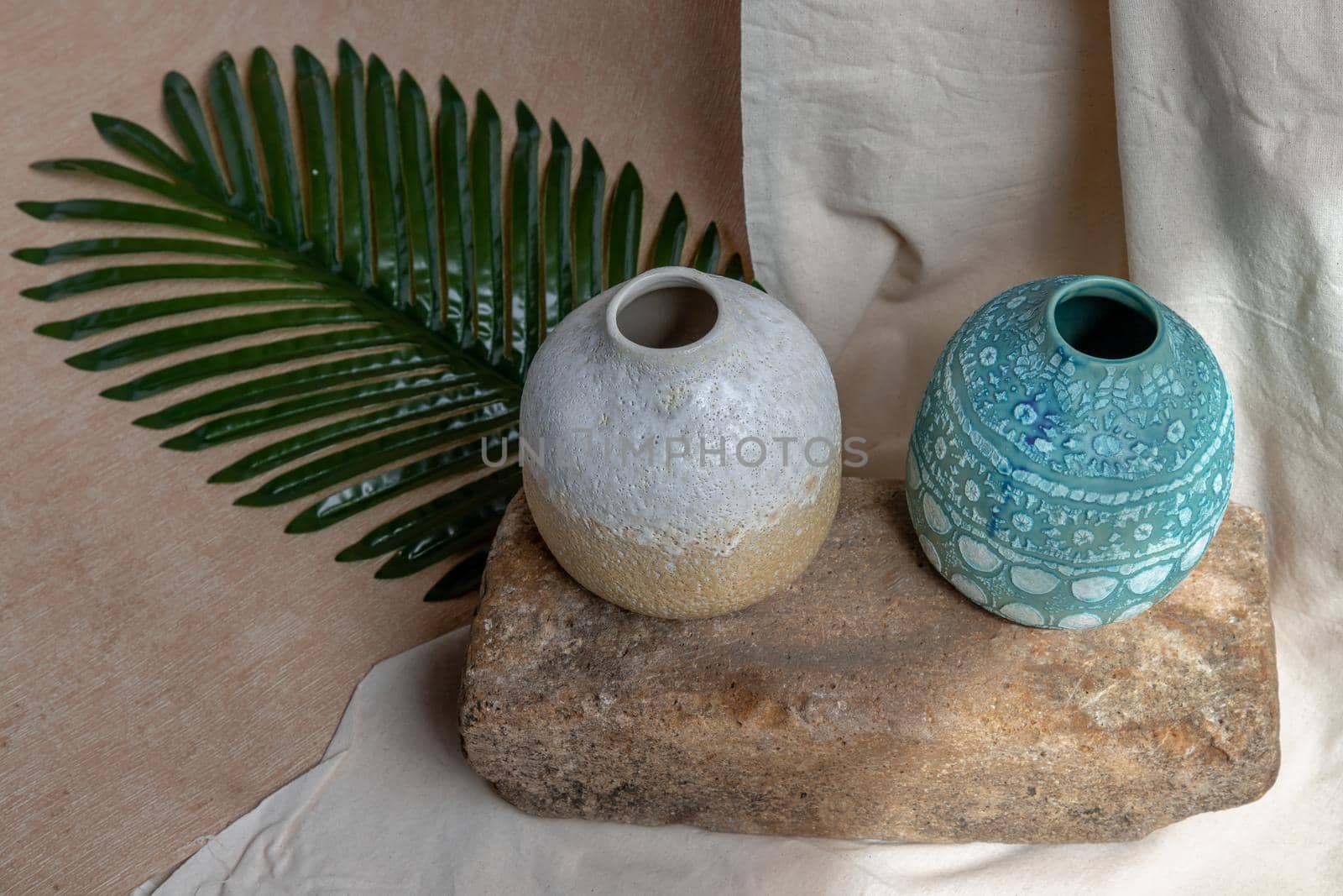 Two handmade ceramic vases on white textured table cloth. Home decor, Copy space, Selective focus.