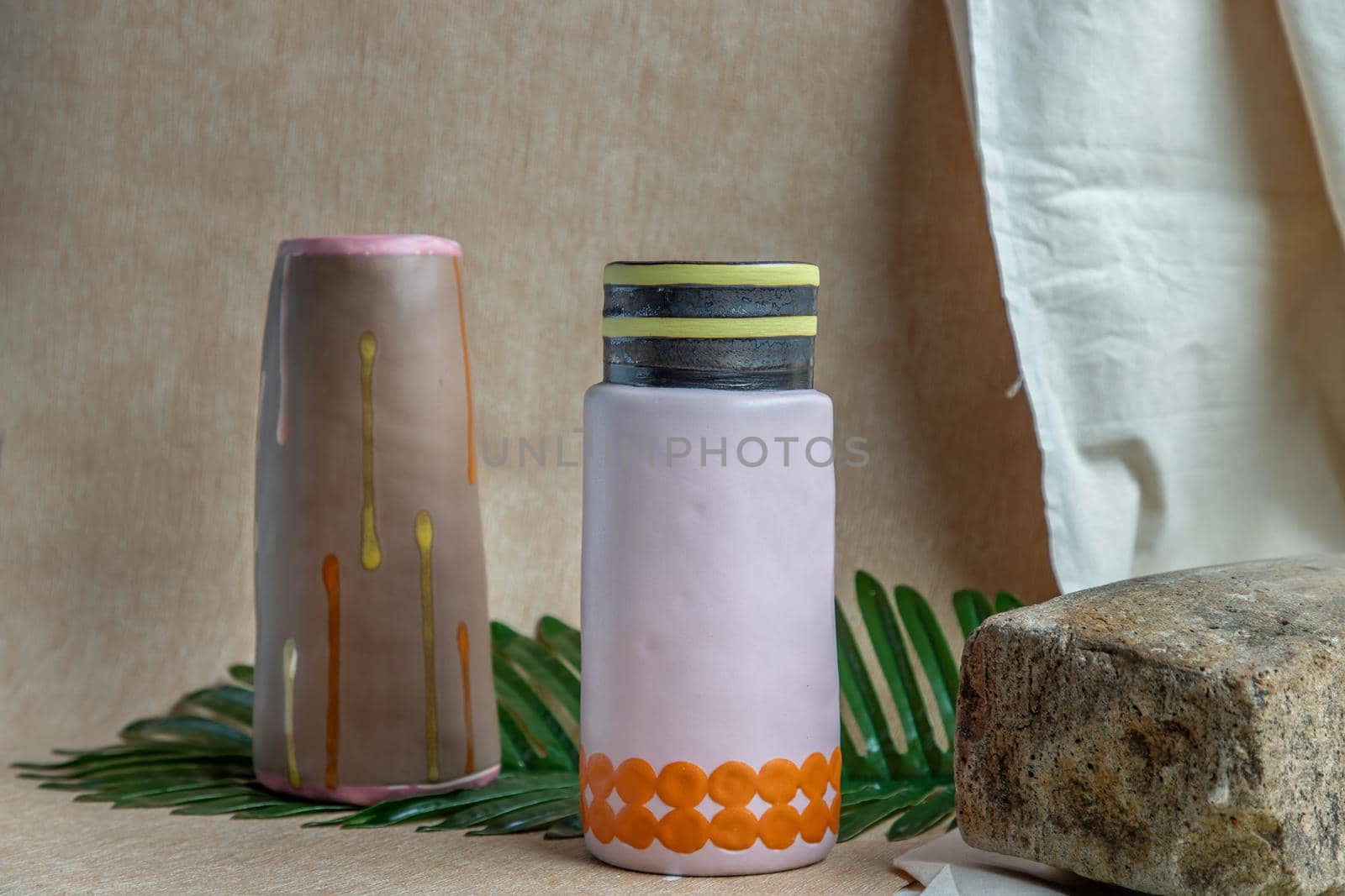 Two Brown and Pink handmade ceramic vases on white textured table cloth. Home decor, Copy space, Selective focus.