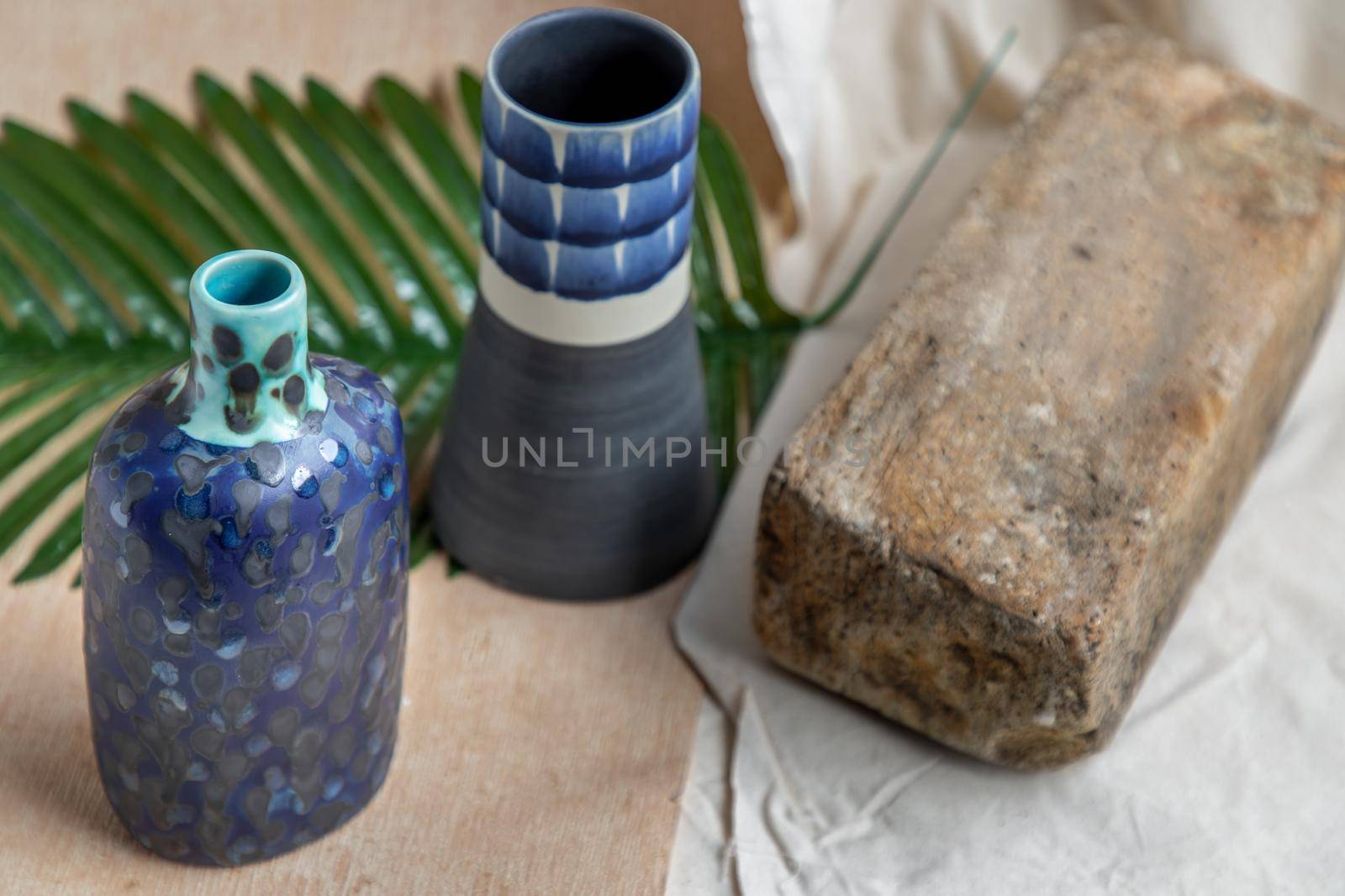 Two Blue handmade ceramic vases on white textured table cloth. Home decor, Copy space, Selective focus.