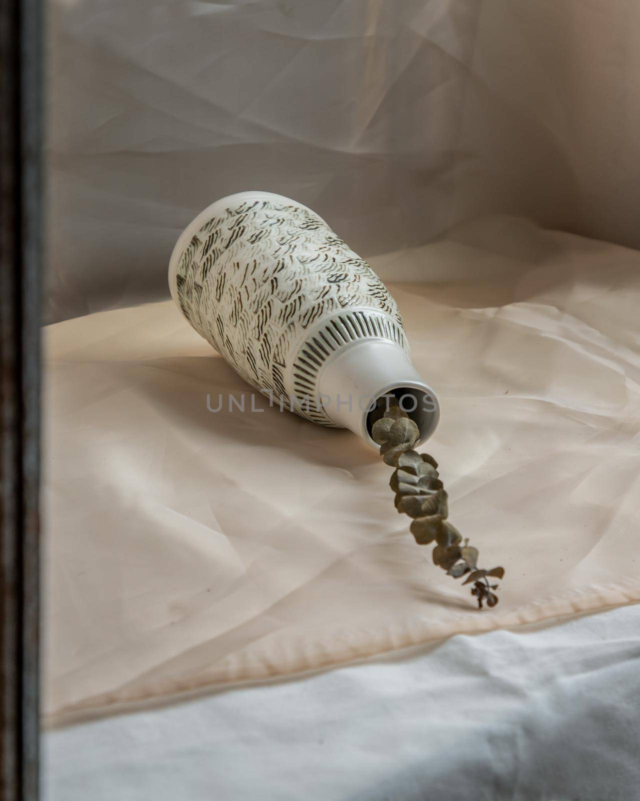 Dried flowers in White ceramic vase bottle shape on Blush textured table cloth. Home decor, Copy space, Selective focus.