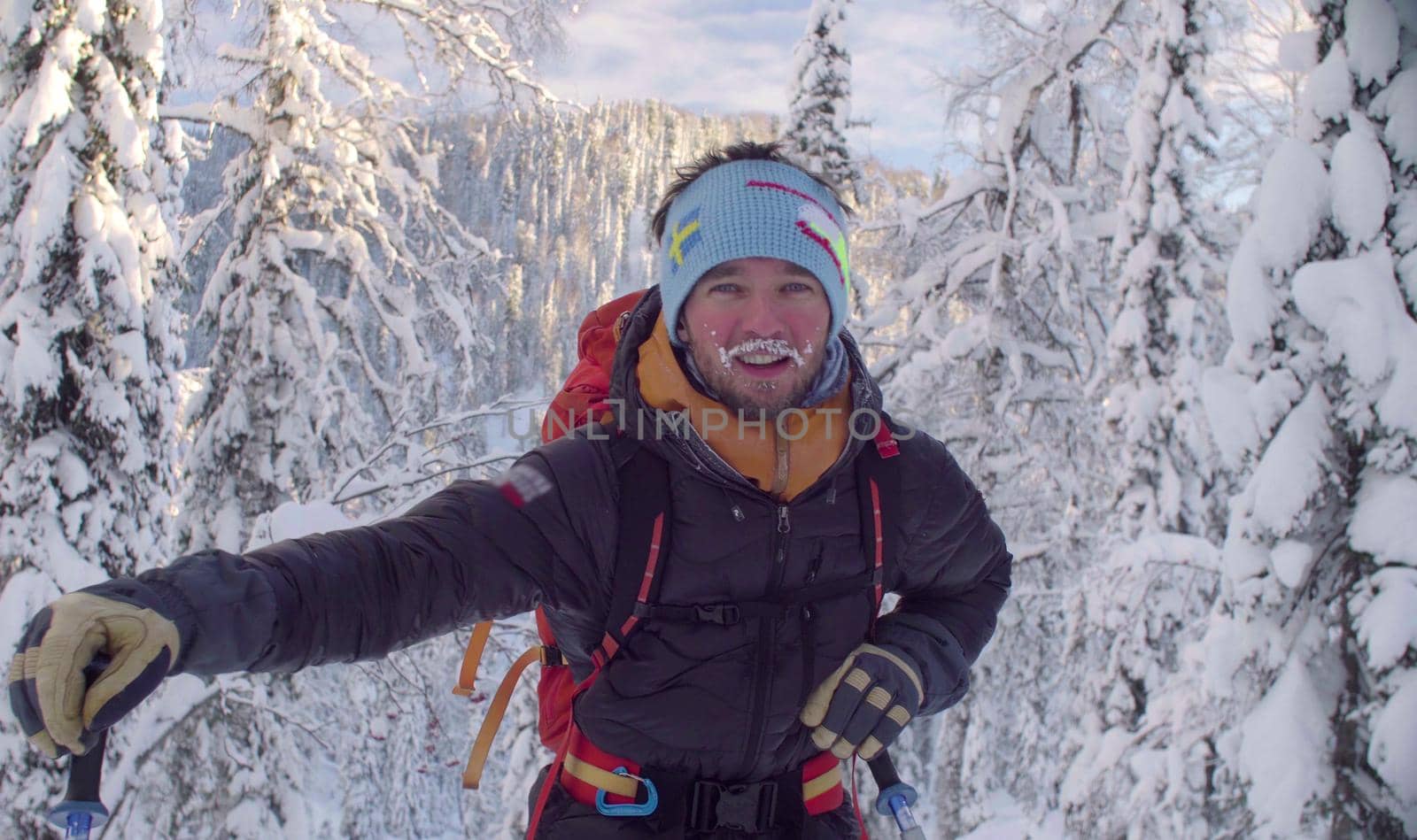 Skitour in Siberia. Portrait of young skier in a snowy forest.