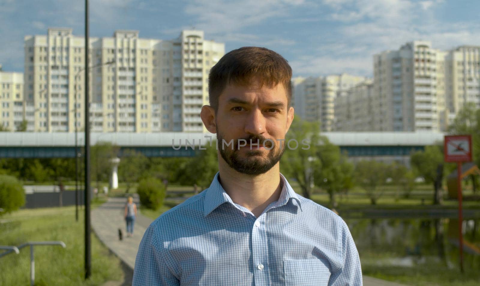 Portrait of a man in blue shirt on the city background