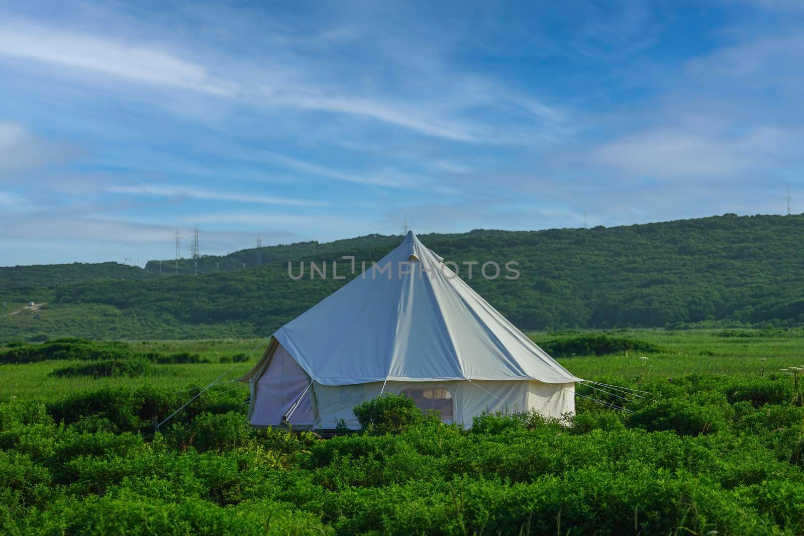 White tent on the background of the natural landscape. Travel and tourism.