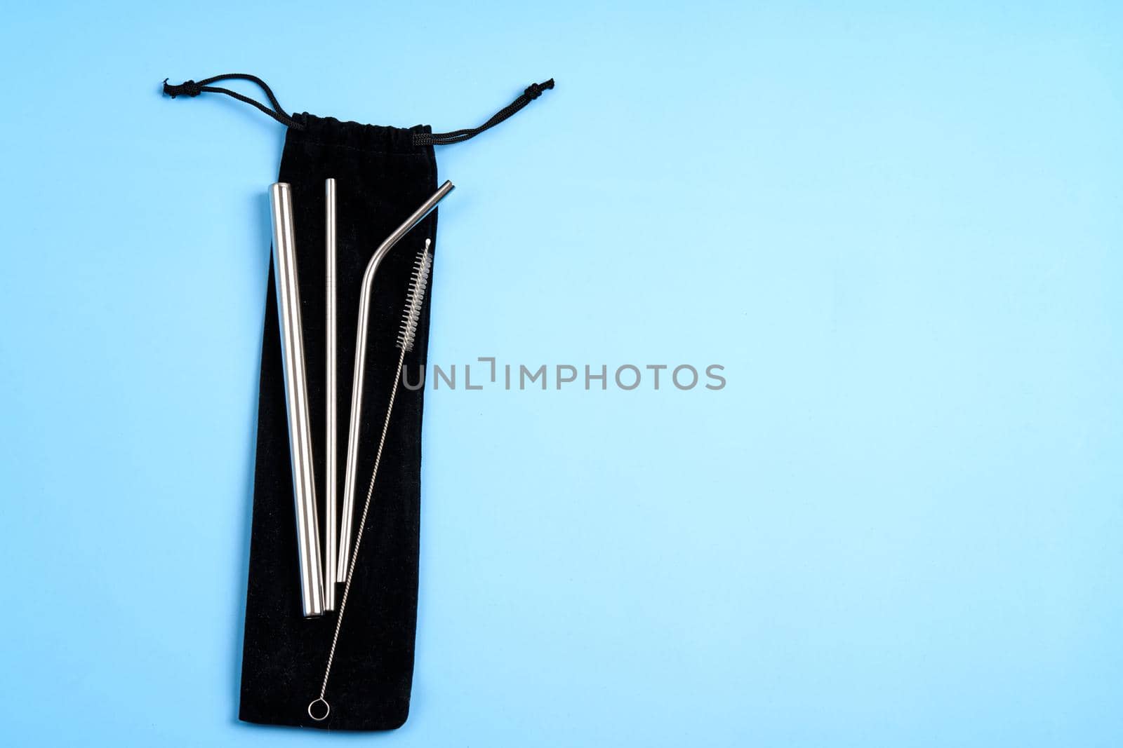 Environmental trend reusable metal beverage straws kit with cleaning tool in transportation bag.