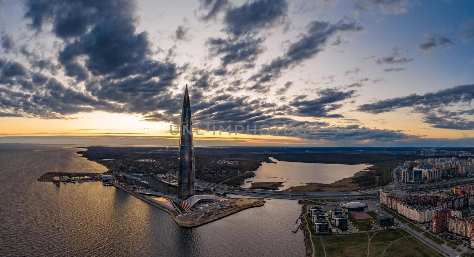 Russia, St.Petersburg, 06 May 2020: Aerial panoramic image of skyscraper Lakhta center at sunset, night illumination is on, It is the highest skyscraper in Europe, Completion of construction, dusk