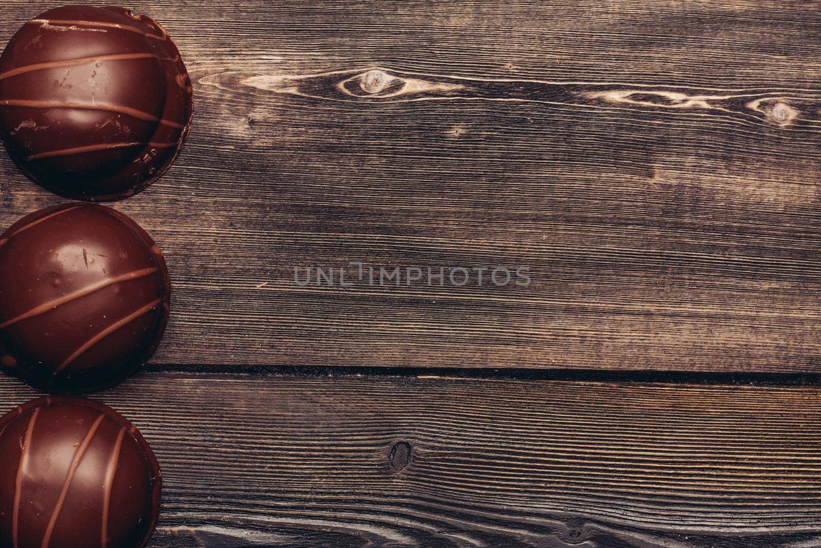 sweets chocolate cakes with icing on wooden background by SHOTPRIME