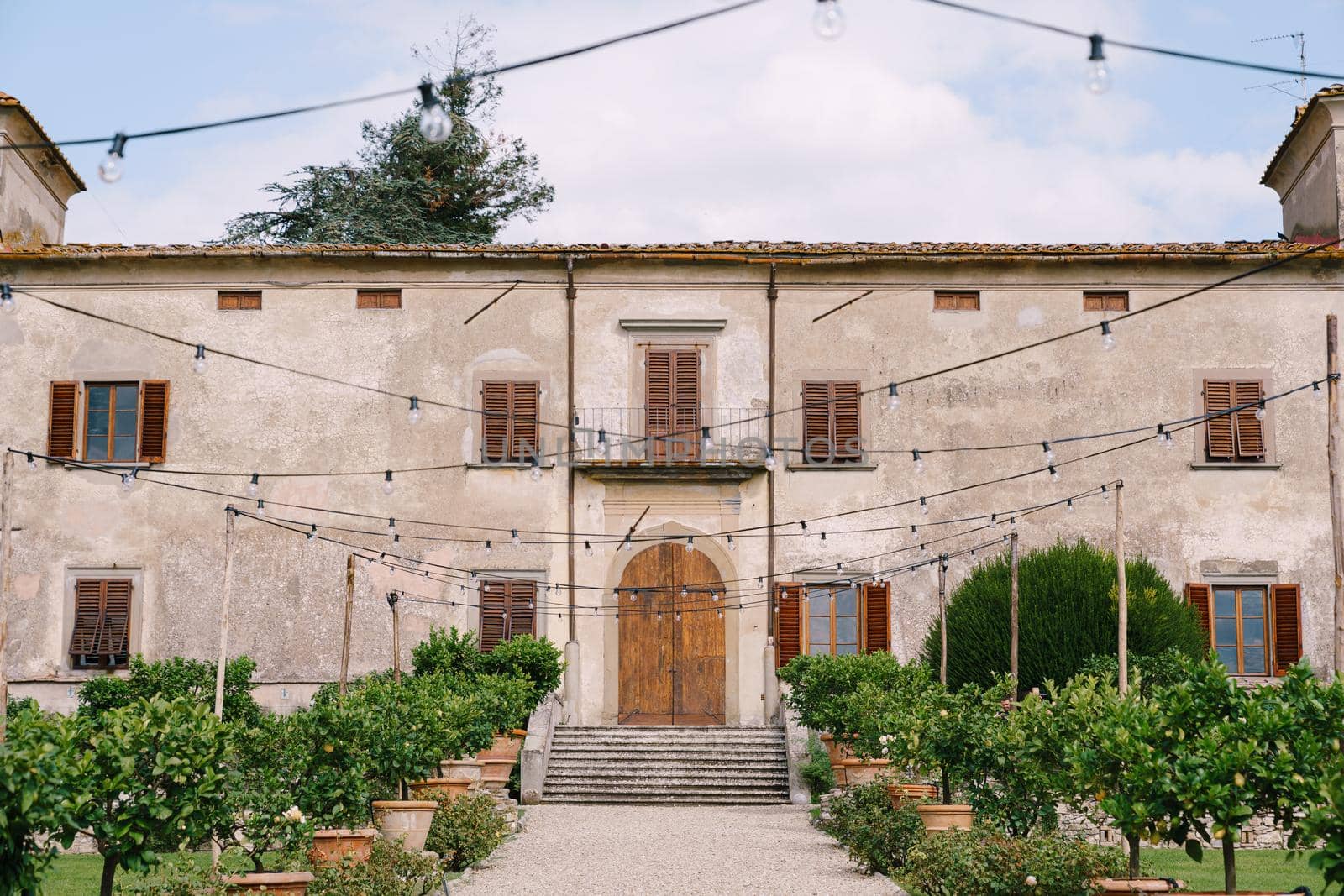 The facade of an old Italian villa. The garden and grounds of the winery in Florence, Italy.