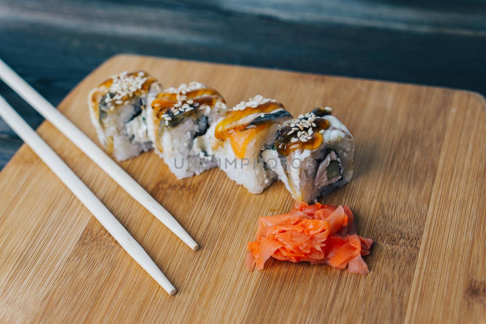 red ginger sushi chopsticks wooden board meal delicacy. High quality photo