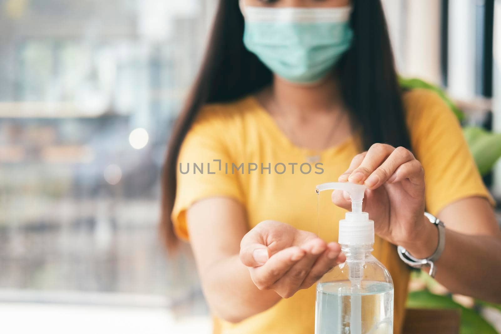 Woman hands using hand alcohol gel or sanitizer bottle dispenser, against corona virus Covid-19. Antiseptic, hygiene and health concept. Prevention of the pandemic virus outbreak