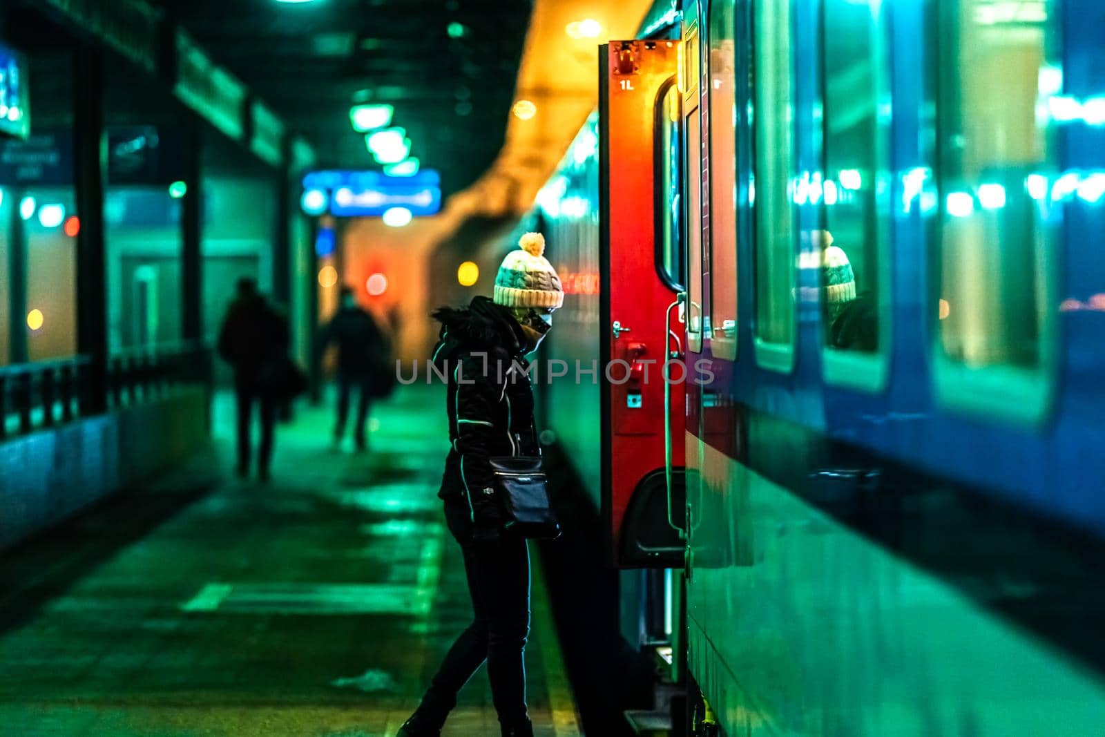 woman boarding a night train at the station by Edophoto