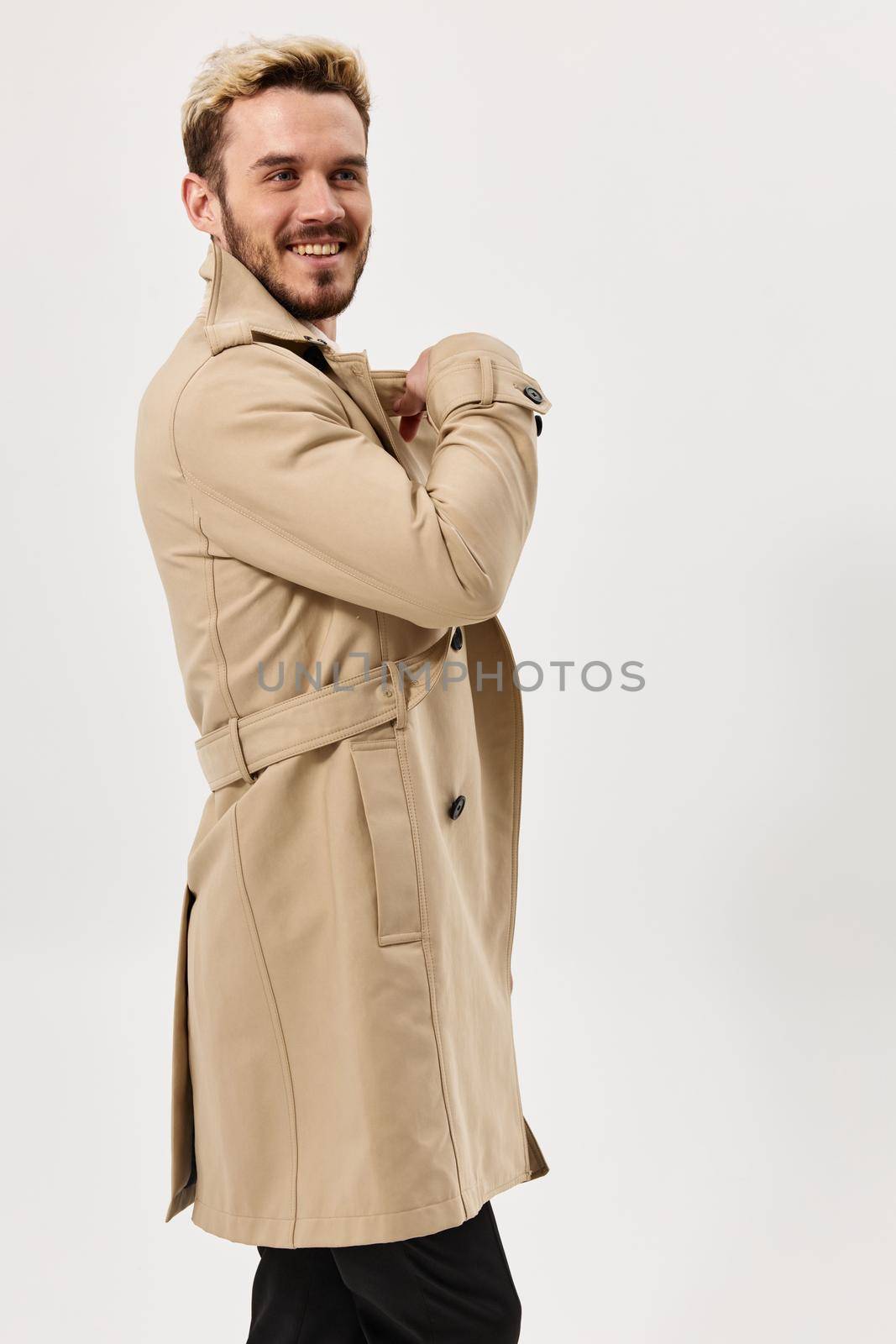 man fashion hairstyle beige coat studio light background by SHOTPRIME