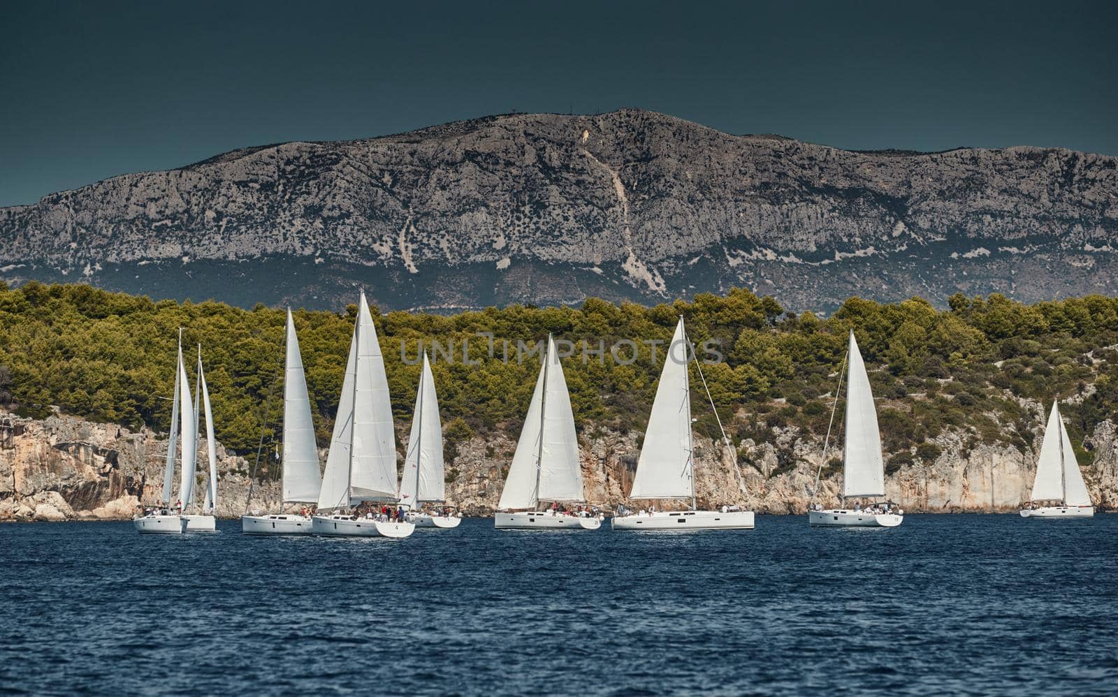 Beautiful sea landscape with sailboats, the race of sailboats on the horizon, a regatta, a Intense competition, bright colors, island with windmills are on background by vladimirdrozdin