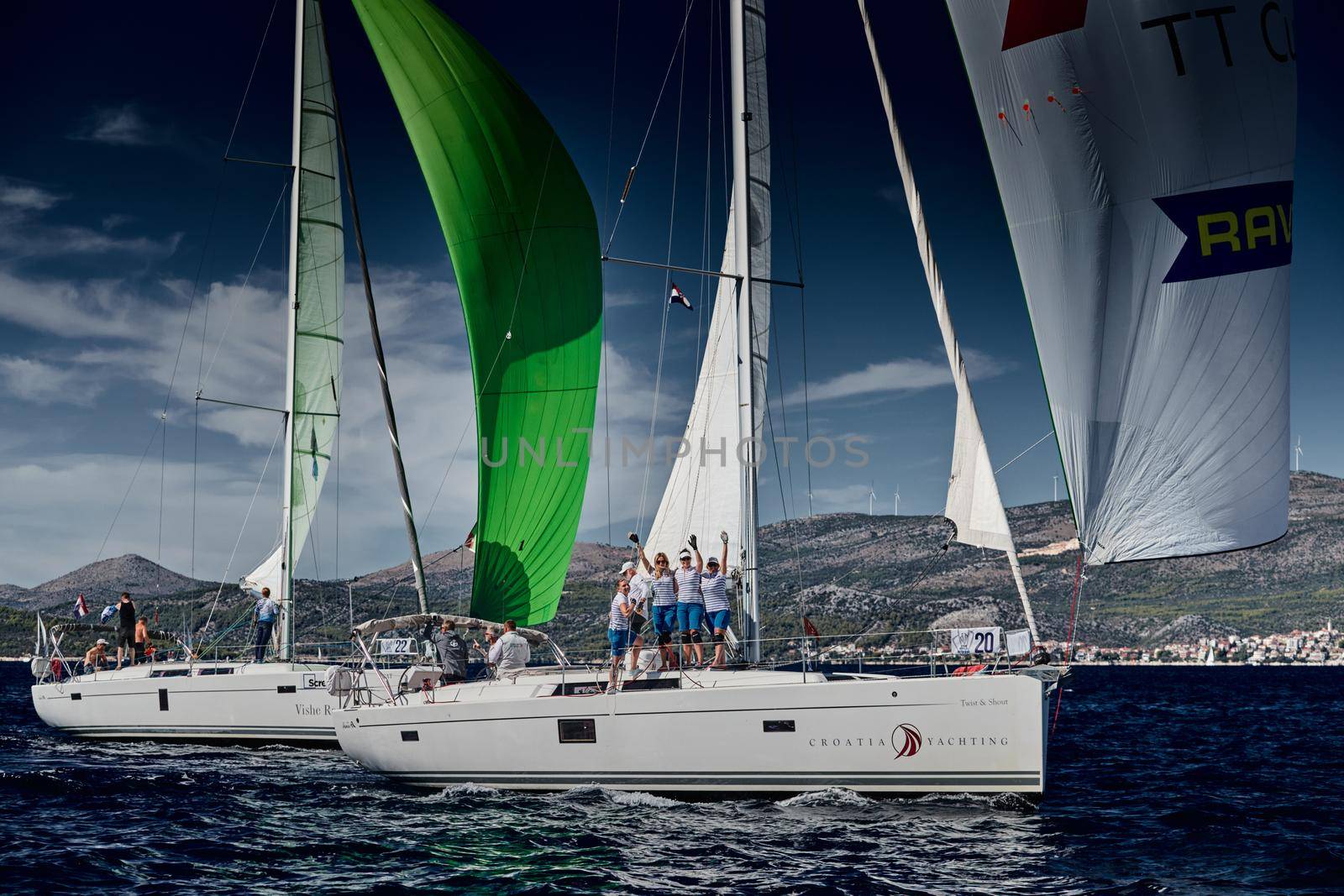 Croatia, Mediterranean Sea, 18 September 2019: The women's team of sailboat celebrates a victory, sailboats compete in a sail regatta, a steering wheel, multicolored spinnakers