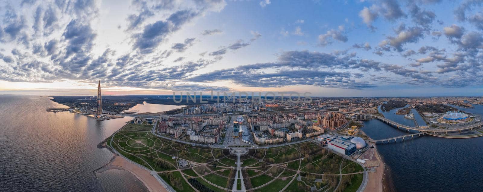 Russia, St.Petersburg, 06 May 2020: Aerial panoramic image of highest skyscraper in Europe Lakhta center at sunset, of Park of 300 anniversaries and of Gazprom arena stadium, night illumination by vladimirdrozdin