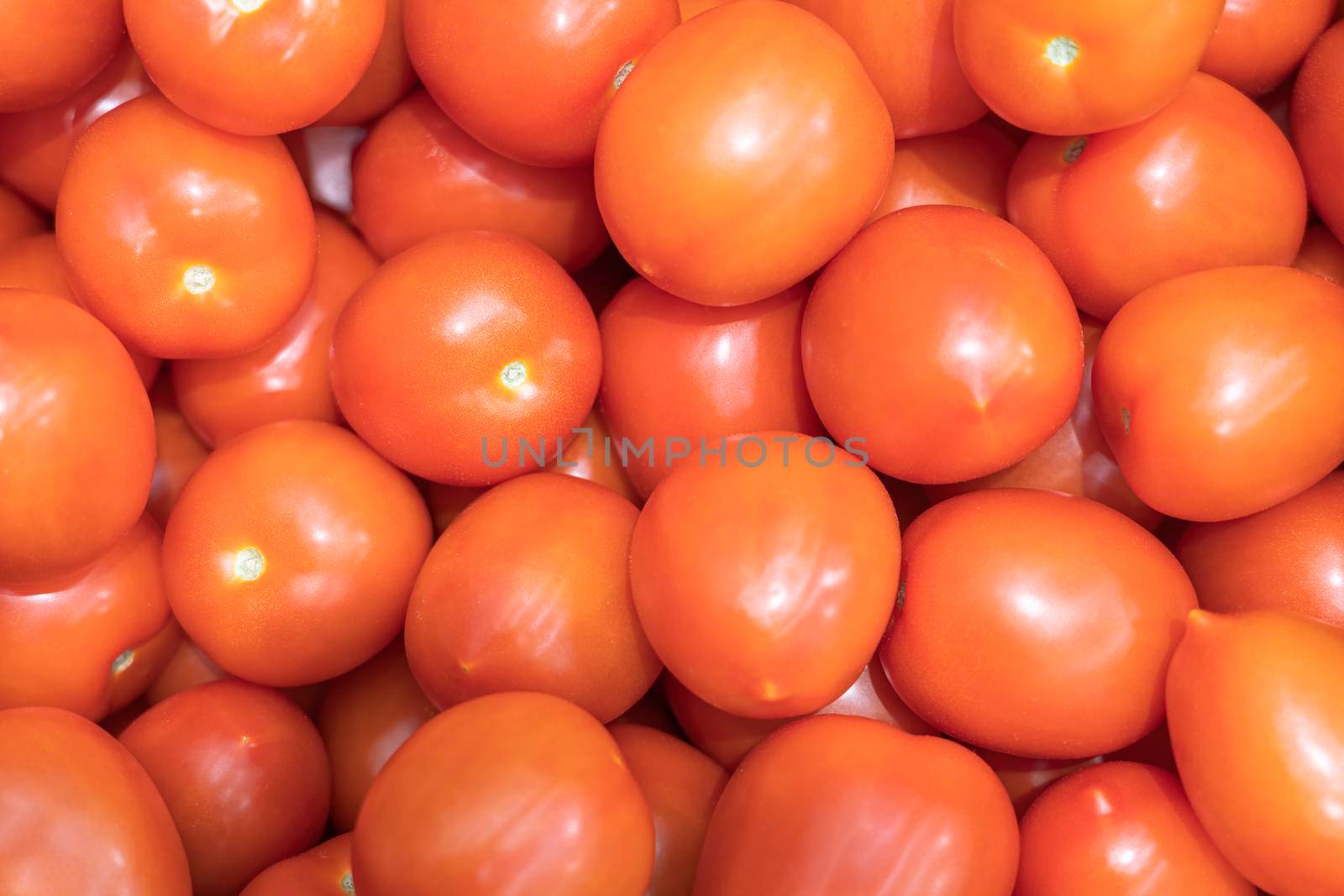 ripe red tomatoes close up on the shelves of supermarket stores. High quality photo