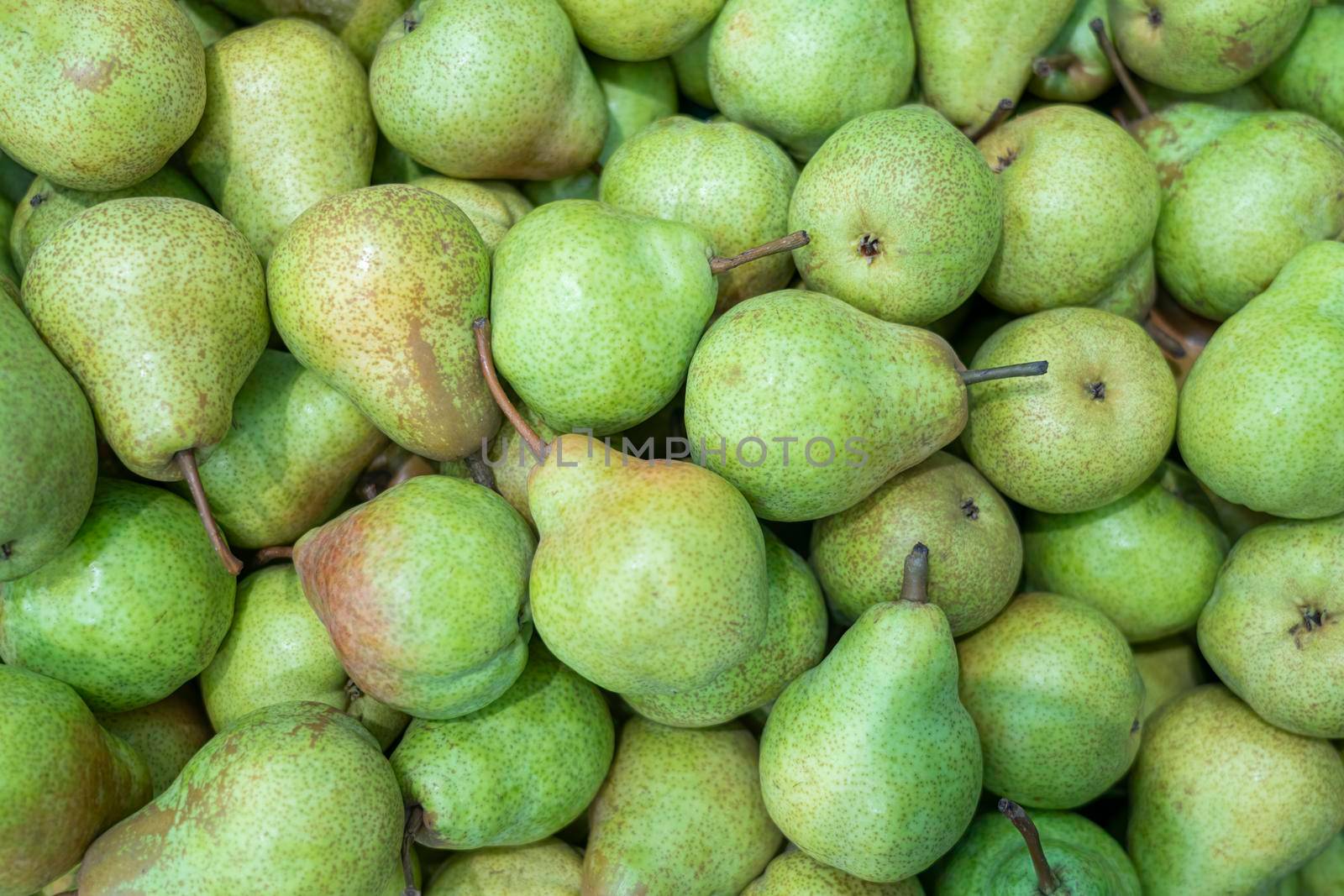 ripe pears close up on the shelves of supermarket stores by roman112007