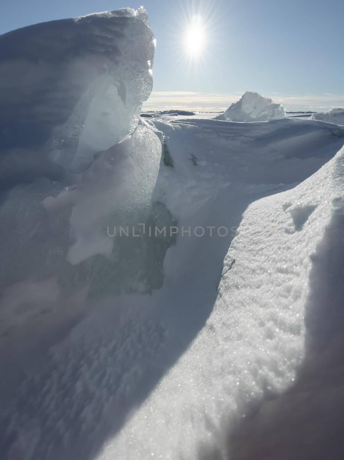 Ice slopes in sunny winter day, transparent ice of blue color, purely blue sky, long shadows, a pure snow-covered virgin soil, snow barkhans, by vladimirdrozdin