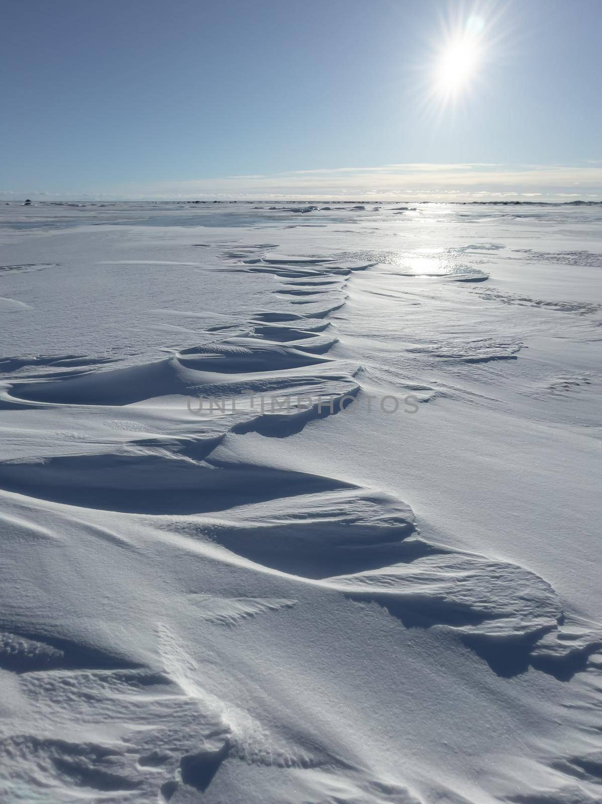 Ice slopes in sunny winter day, transparent ice of blue color, purely blue sky, long shadows, a pure snow-covered virgin soil, snow barkhans, by vladimirdrozdin