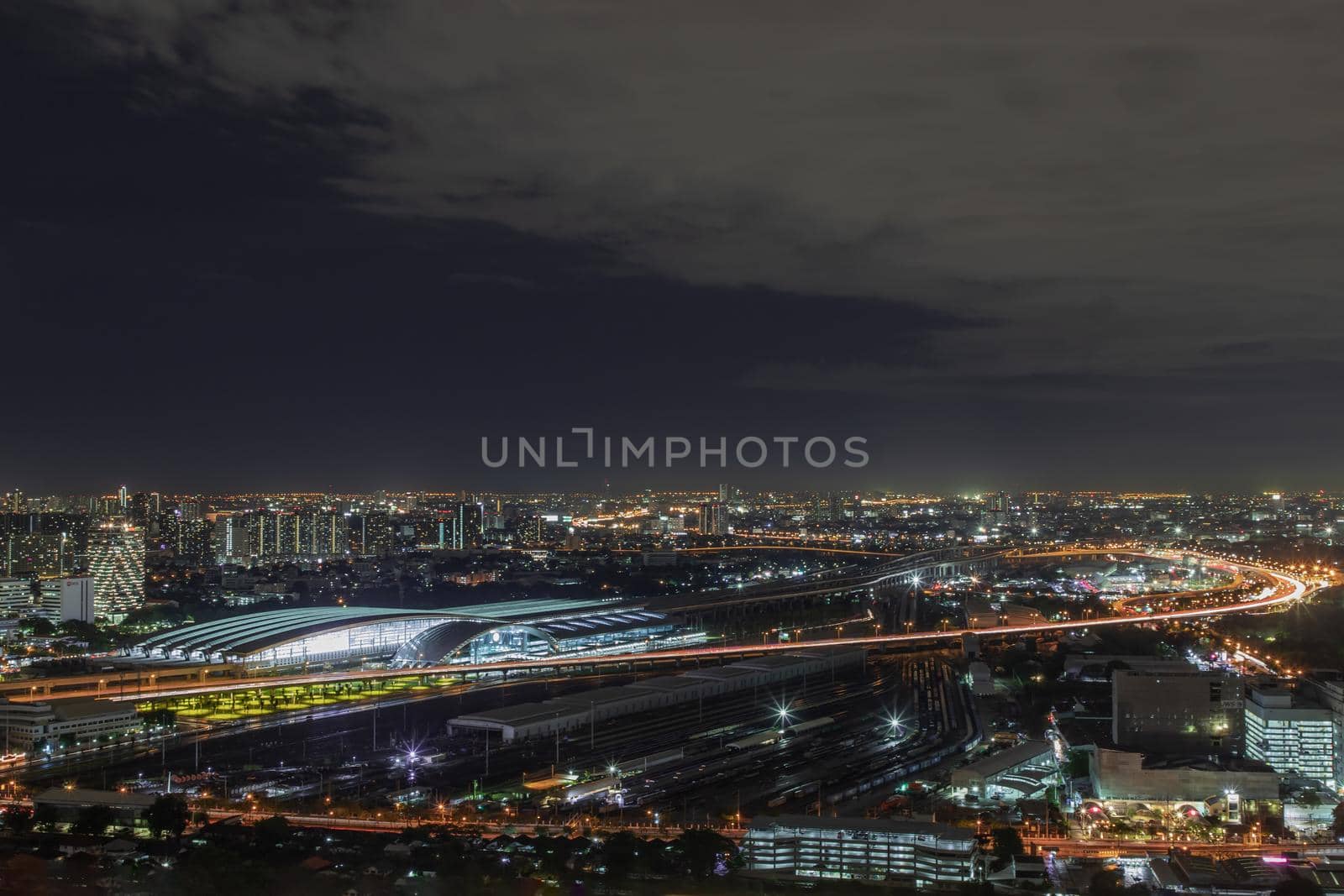 Bangkok, thailand - Aug 28, 2020 : Aerial view of Bang Sue central station with skyscrapers background at night. Selective focus.
