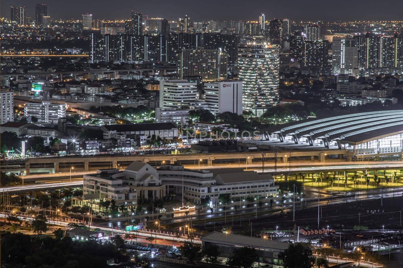 Bangkok, thailand - Aug 28, 2020 : Aerial view of Bang Sue central station with skyscrapers background at night. Selective focus.