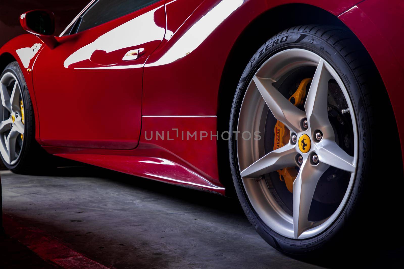 Bangkok, Thailand - 06 Jan 2021 : Close-up of Wheel of Red Ferrari Sports Car.  Ferrari is Italian sports car. Selective focus.