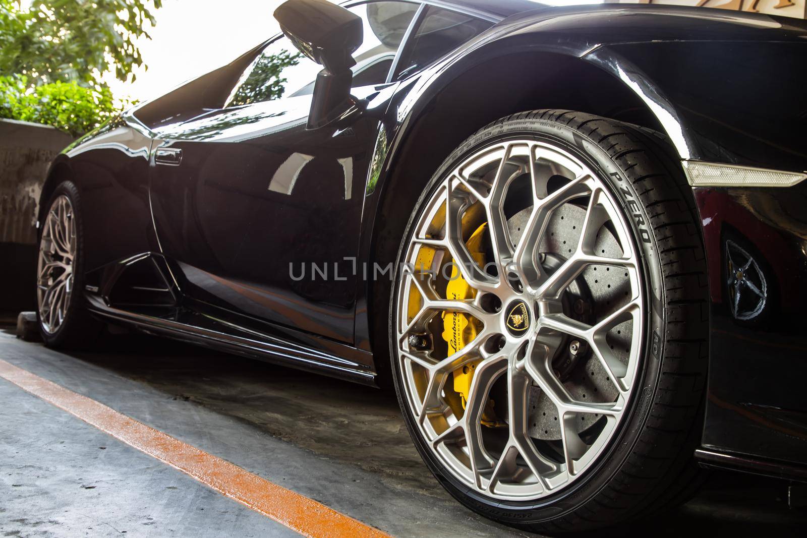 Bangkok, Thailand - 06 Jan 2021 : Close-up of Wheel of Black Lamborghini Sports Car. Lamborghini is Italian sports car. Selective focus.