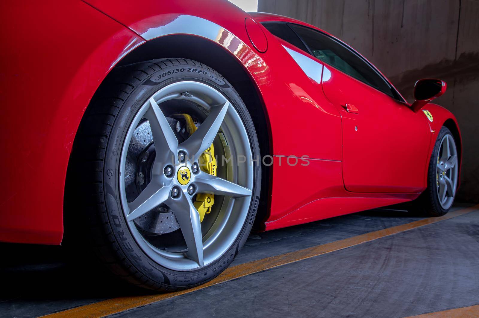 Bangkok, Thailand - 06 Jan 2021 : Close-up of Wheel of Red Ferrari Sports Car.  Ferrari is Italian sports car. Selective focus.