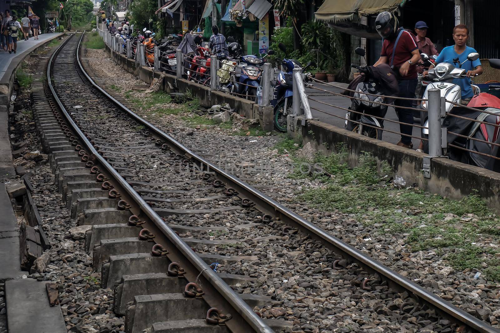 Bangkok, Thailand - July 10, 2019 : Railway tracks adjacent to the community. Transportation and travel concept. Focus and blur.