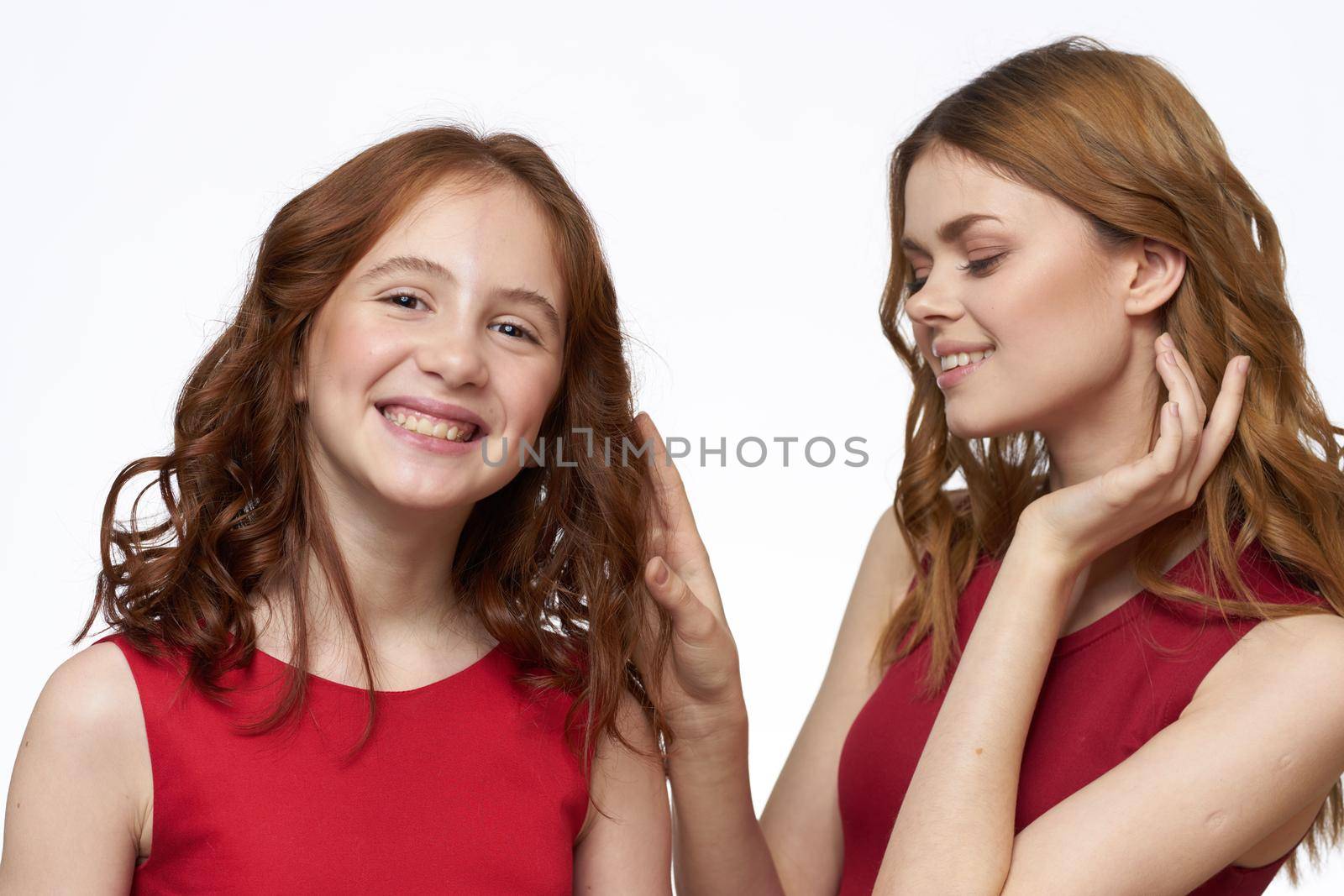 Cheerful mom and daughter hugs joy lifestyle family light background. High quality photo