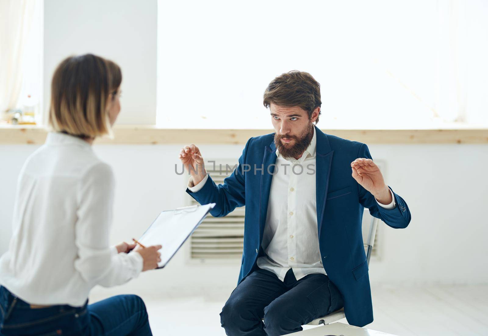 A man in a suit at a psychologist's office near the window by SHOTPRIME