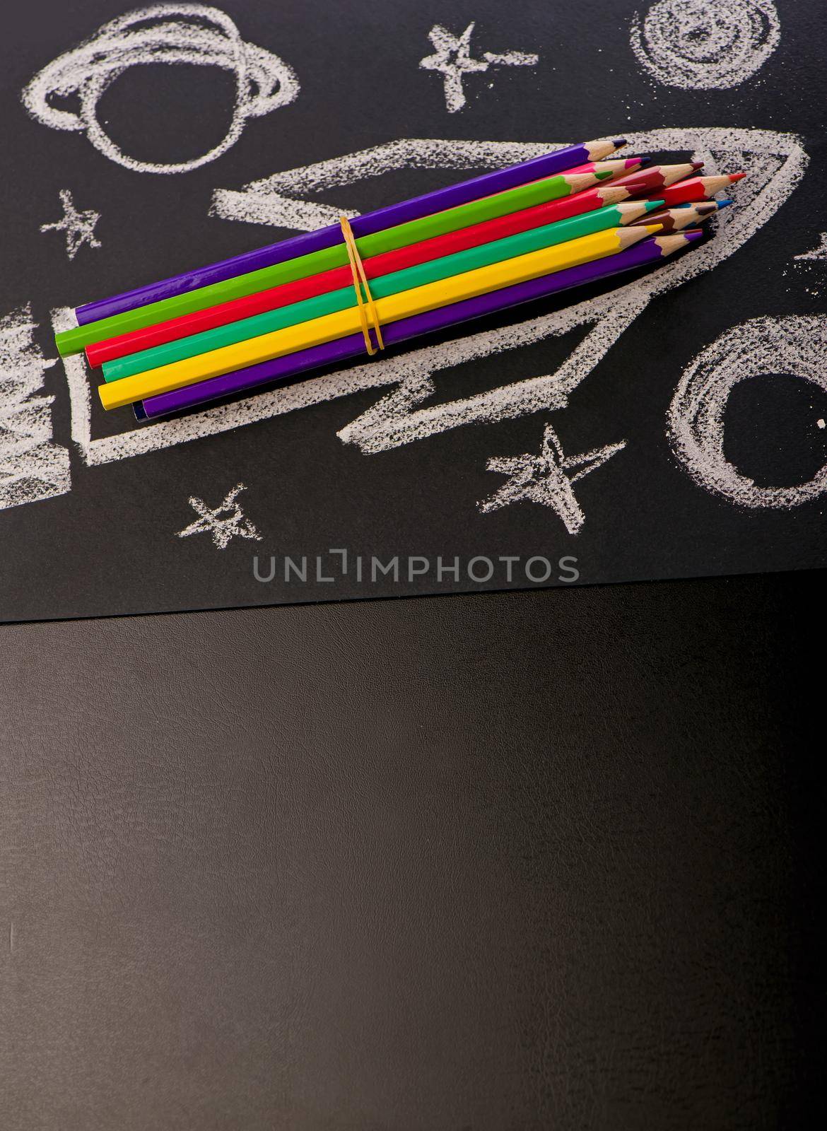 School supplies on blackboard background.