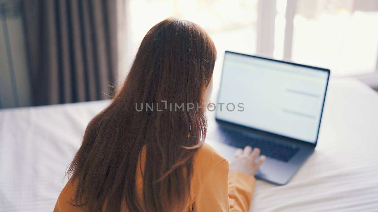 woman at laptop or already in bed rest internet work by SHOTPRIME