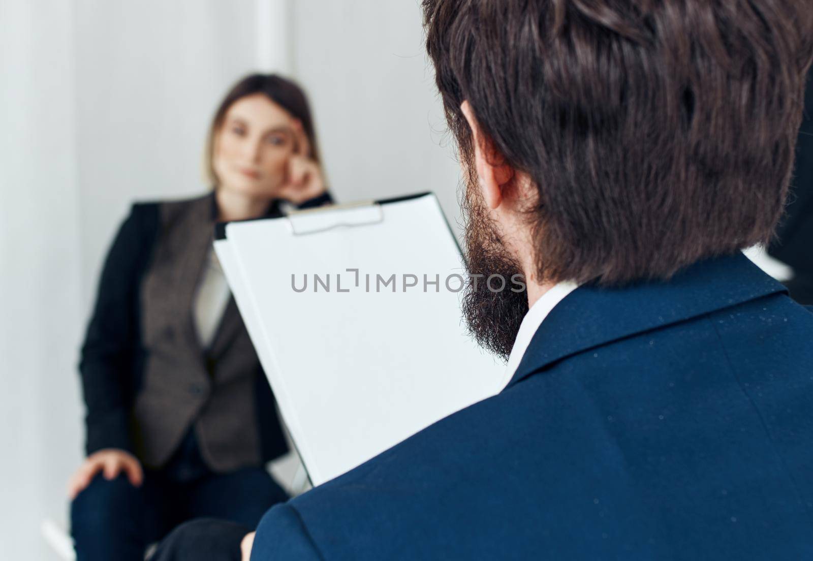 Business man communicates with a woman in a suit, staff vacancies resume. High quality photo