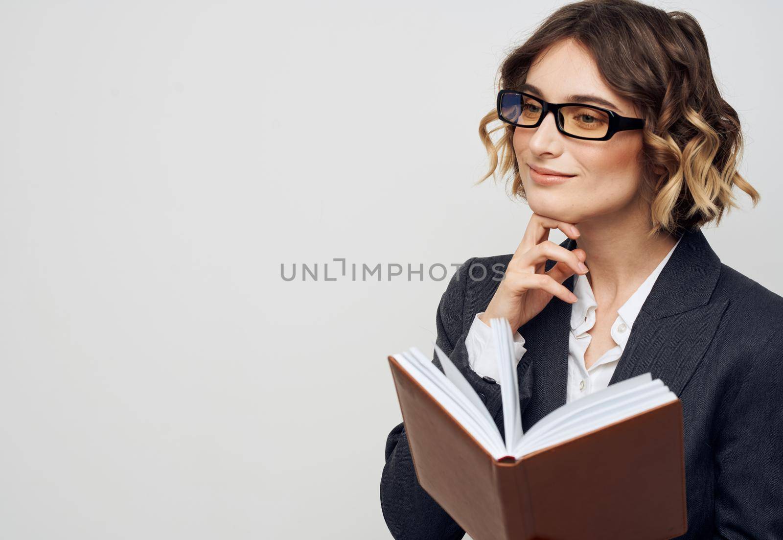 Woman model in classic suit on a light background documents business finance. High quality photo