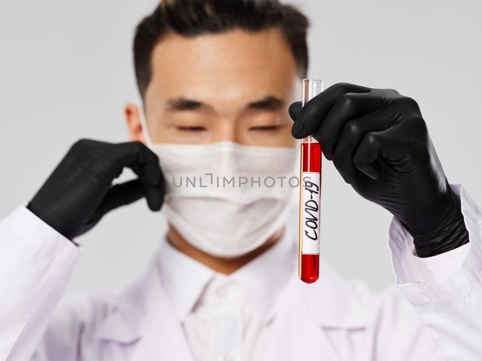 male doctor in black gloves tests and diagnostics blood biochemistry research. High quality photo