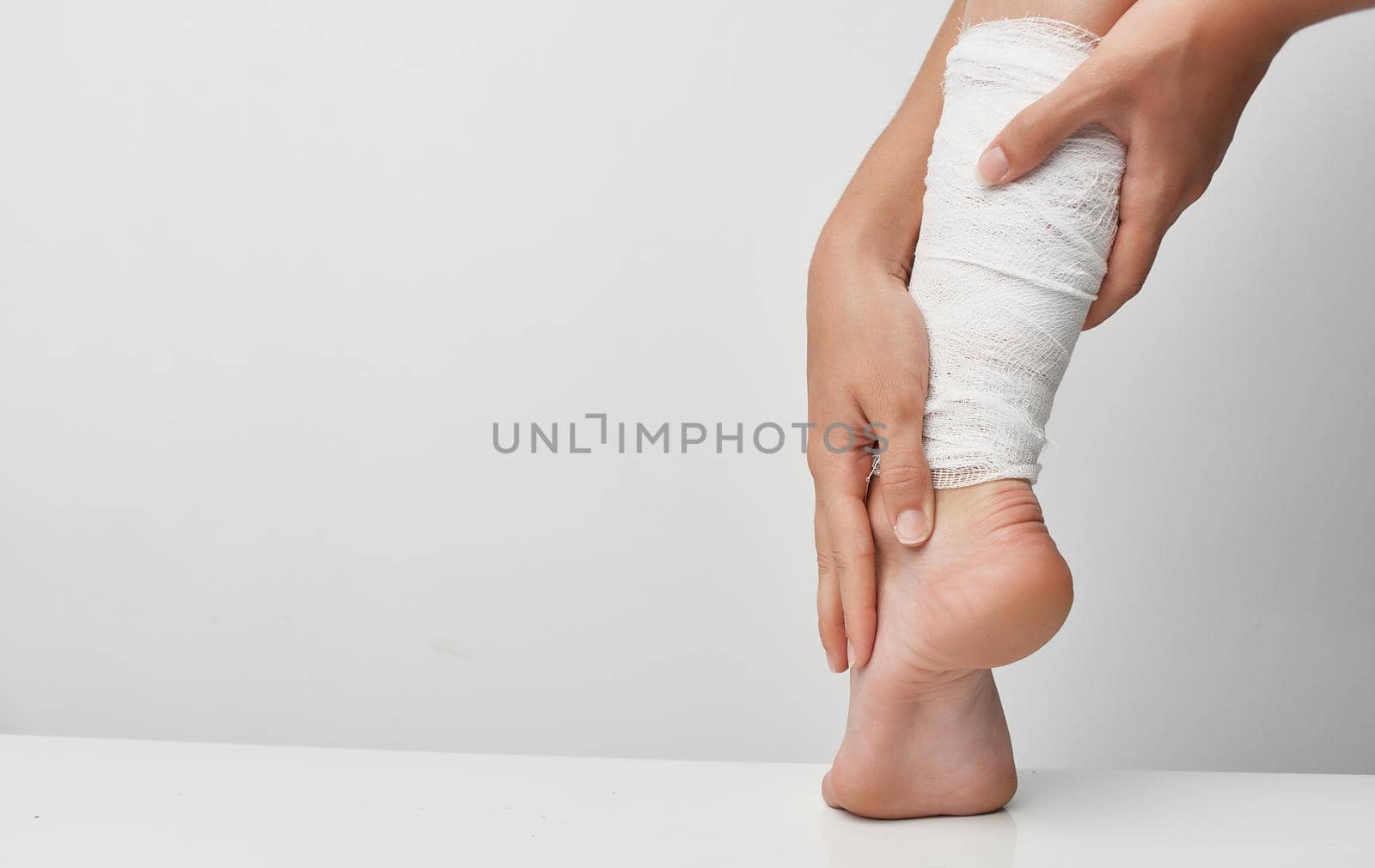 bandaged leg injury medicine gray background problems. High quality photo