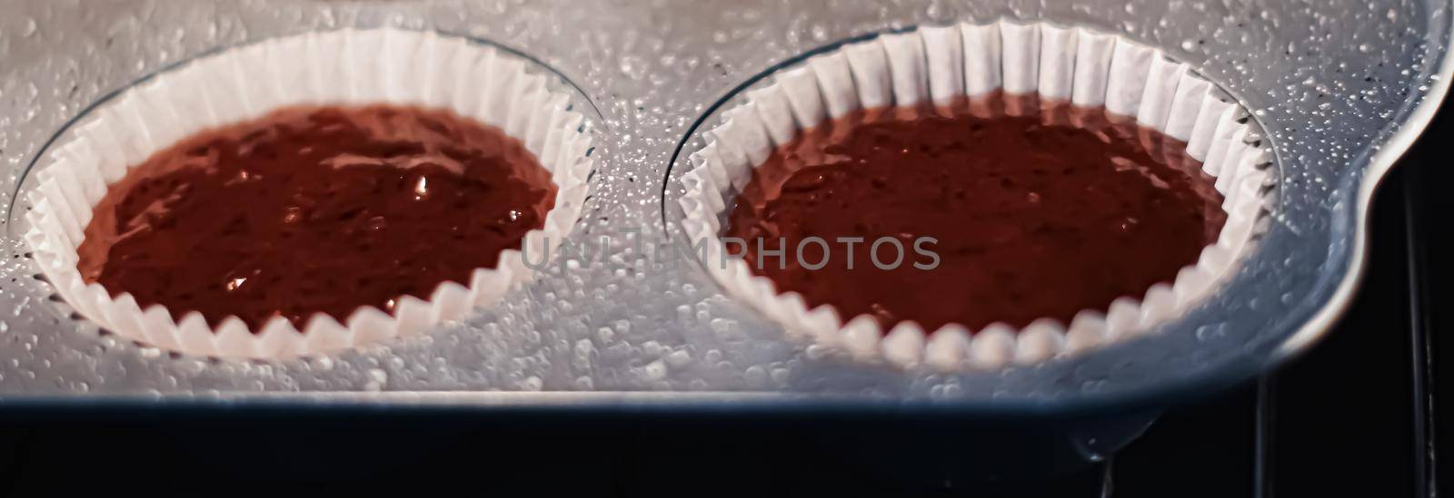 Chocolate muffins baking in the oven, homemade comfort food recipe concept