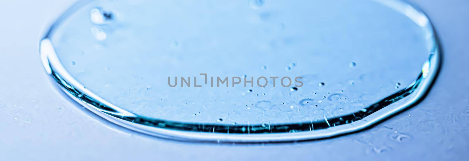 Blue gel texture on glass as cosmetics background, hygiene and science by Anneleven