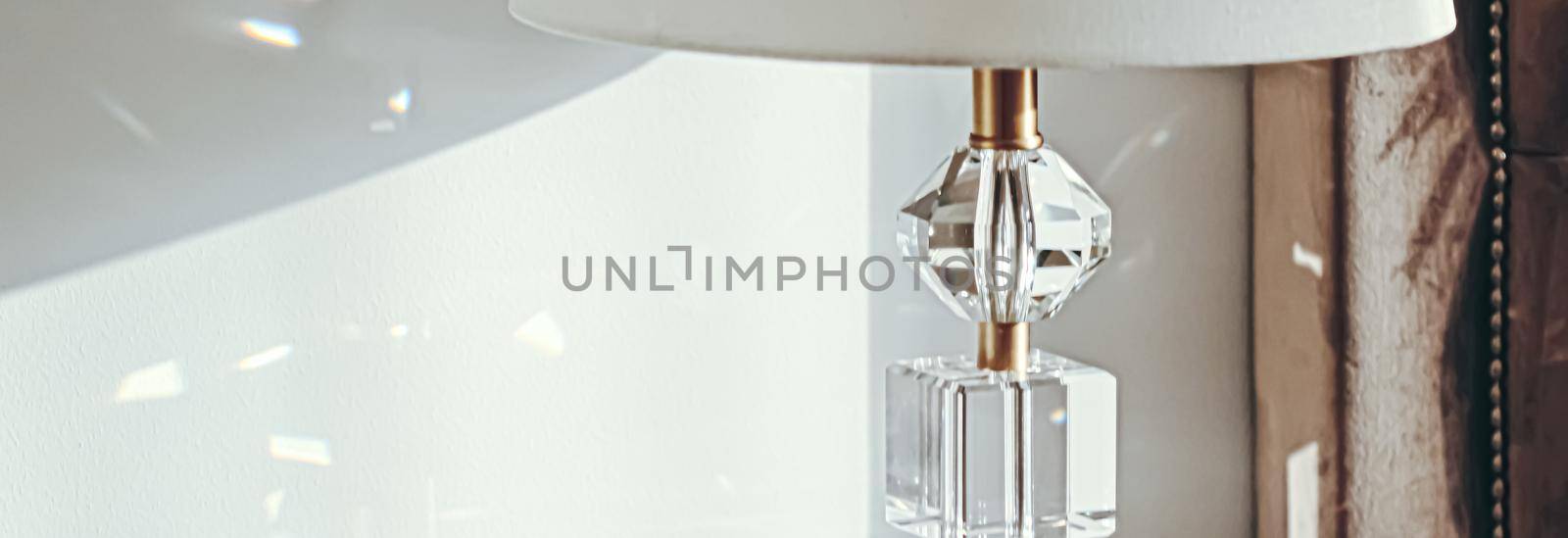 Gold and crystal details of a bedside lamp with shadows at sunset, luxury home decor by Anneleven