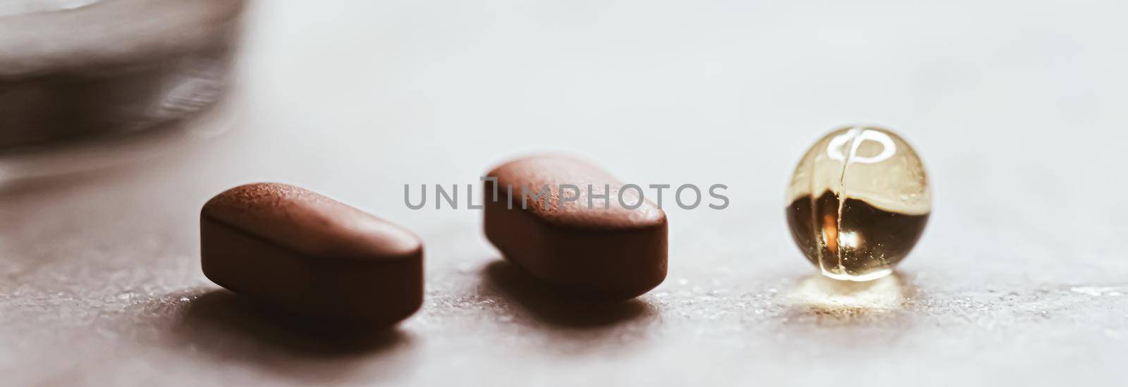 Medical pills and glass of water, health and wellness closeup