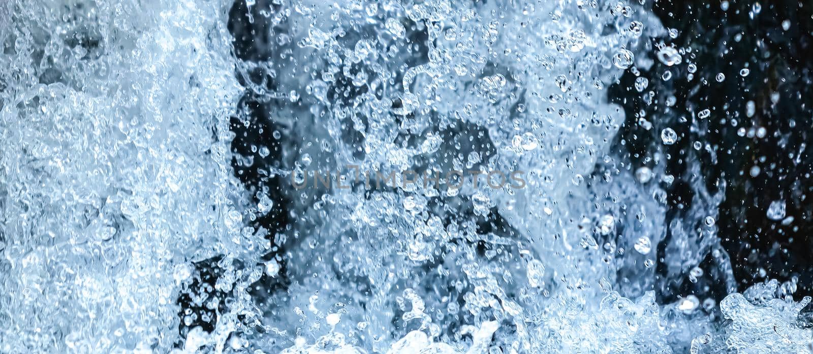 Splashing water in a waterfall. Abstract background